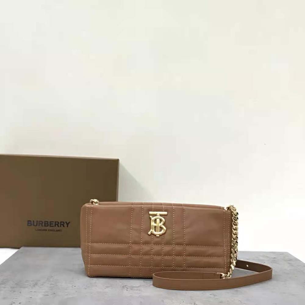 Side profile showing shape and adjustable strap of Burberry Small Lola Bag