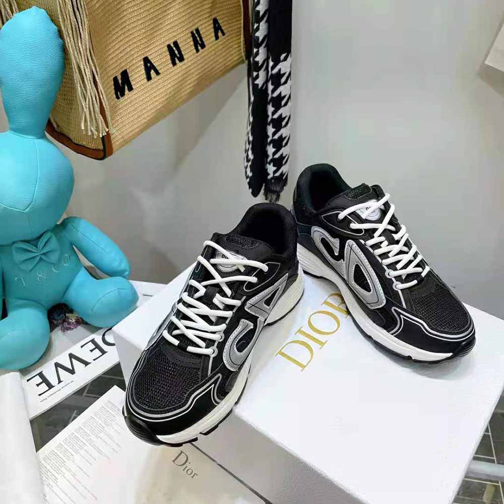 Close-up of black mesh and Dior embossed logo on sneaker