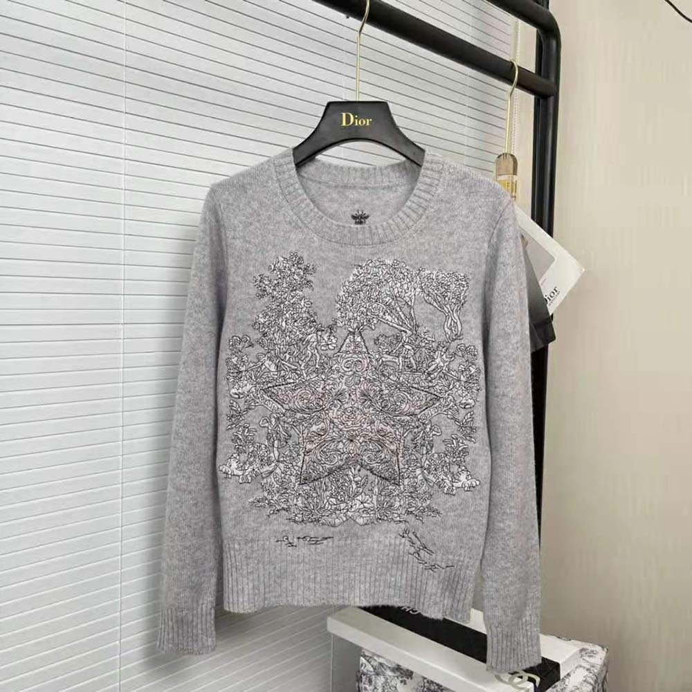 Close-up of Dior signature embroidery on gray cashmere sweater