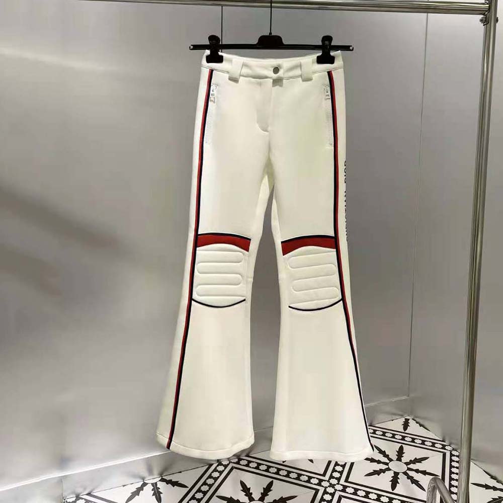 Close-up of white technical fabric and Dior hardware on Dioralps ski pants