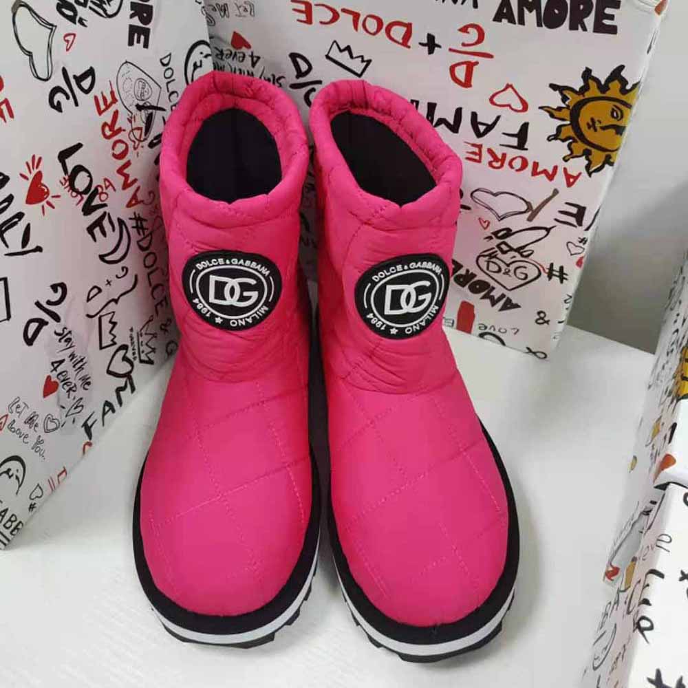 Close-up of DG logo hardware on pink nylon ankle boots
