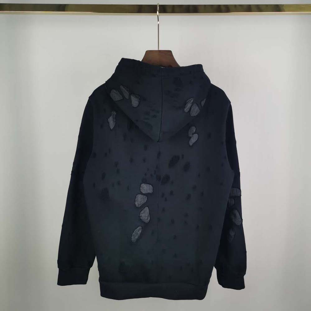 Side profile showing silhouette of Givenchy Men Paris Destroyed Hoodie