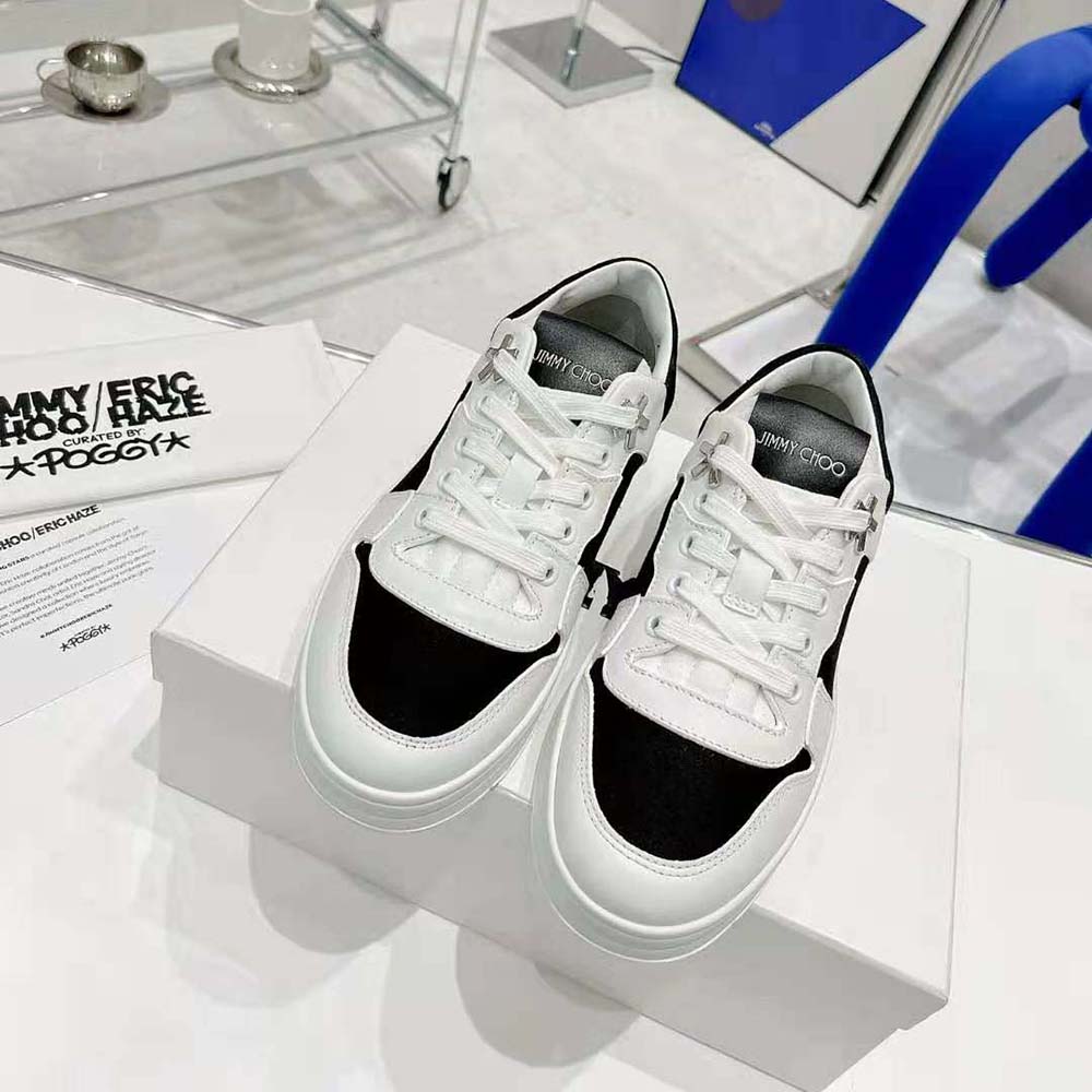 Close-up of black canvas and white calf leather on Jimmy Choo unisex trainers