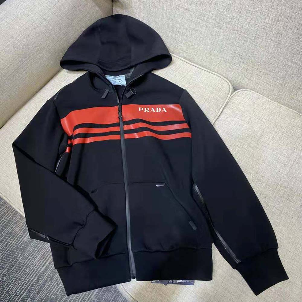 Close-up of Prada logo hardware on printed technical fabric jacket