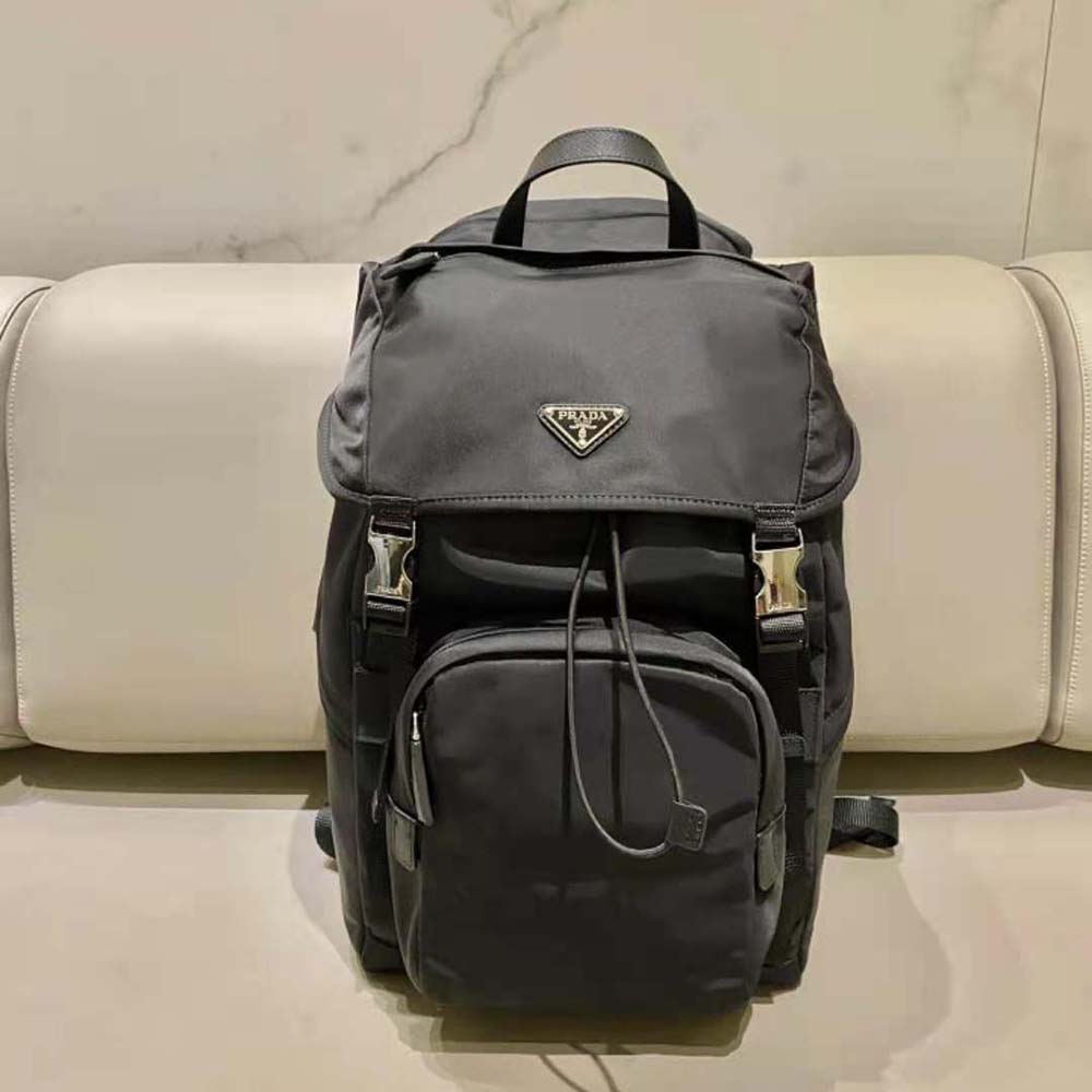 Side angle showing matte hardware on Prada Men Re-Nylon backpack