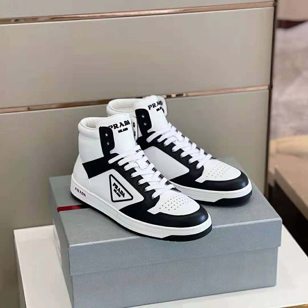 Close-up of lace-up and Prada logo hardware on sneakers
