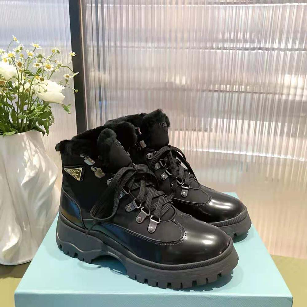 Close-up on black leather and nylon texture with Prada logo hardware