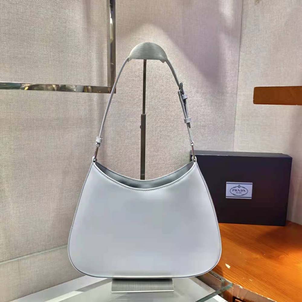 Side angle showing shoulder strap and crescent shape of Prada Women Cleo bag