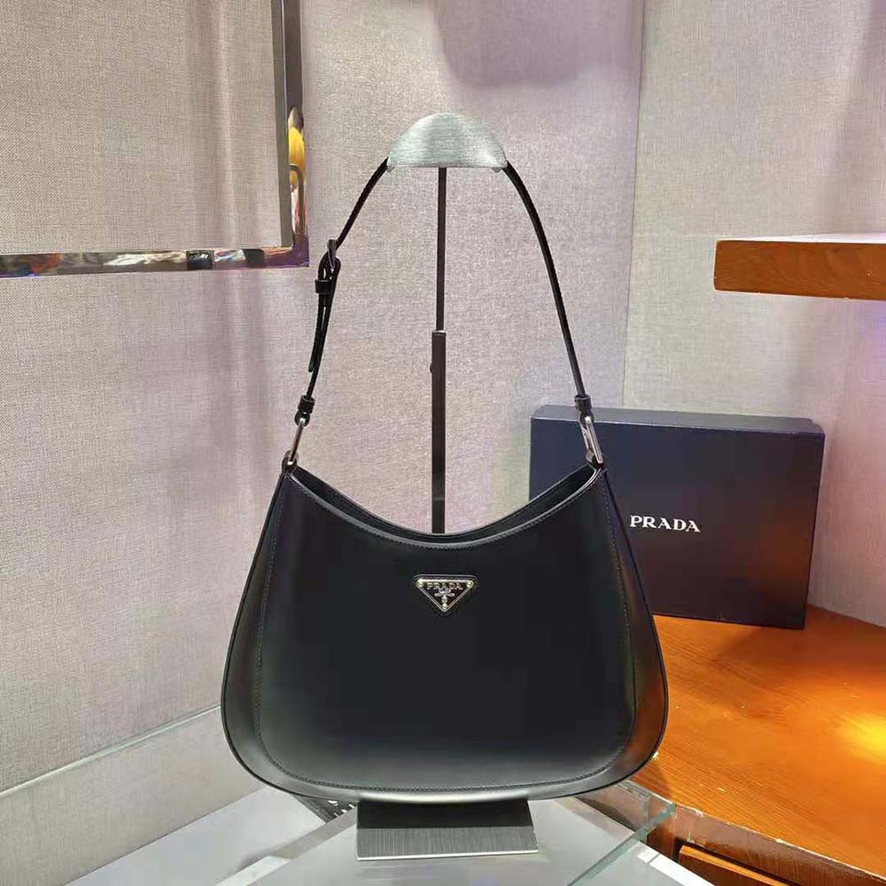 Close-up of brushed leather texture and gold hardware on Prada Women Cleo Shoulder Bag