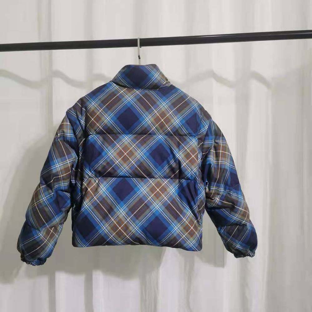 Side angle of Prada Women Cropped Plaid Puffer Jacket-Blue highlighting silhouette