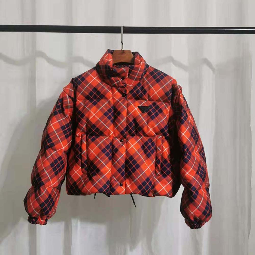 Close-up of red plaid pattern and metal zipper on Prada jacket