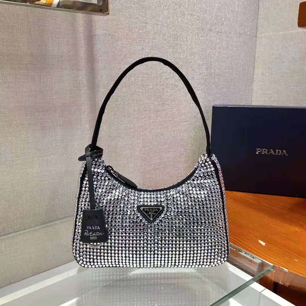 Close-up of crystal closure and duchesse satin texture on Prada mini-bag