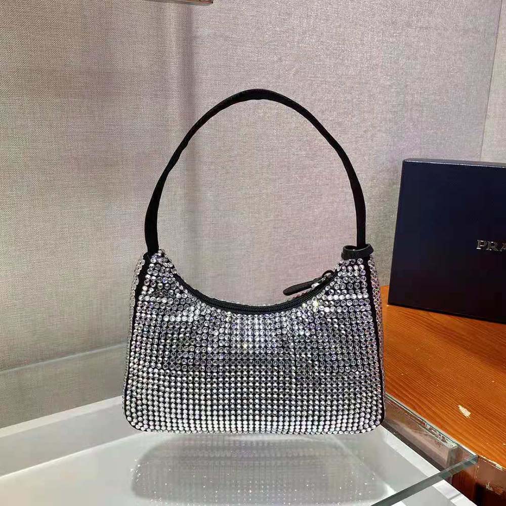 Side angle highlighting black satin and silver-tone hardware on Prada bag