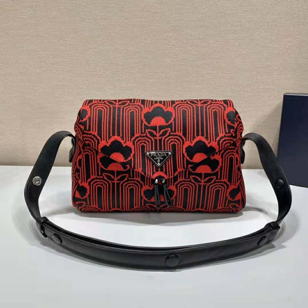 Side angle showing leather trim and adjustable strap of Prada Signaux Bag-Red