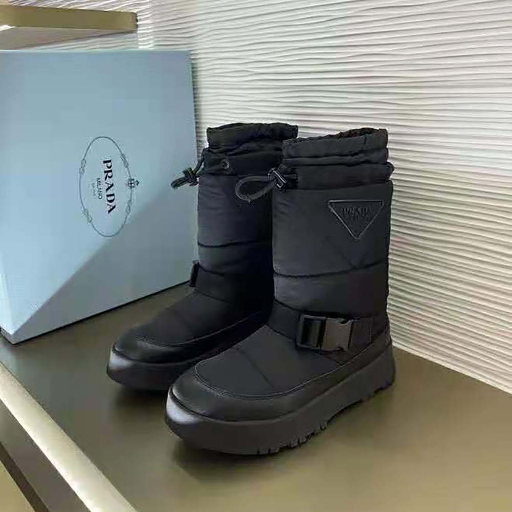 Close-up of zip and signature Prada hardware on booties