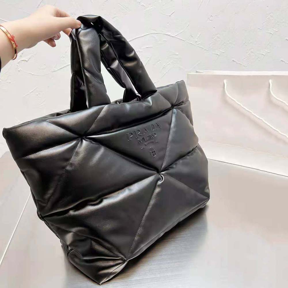 Side angle of Prada Women Padded Nappa Tote Bag-Black highlighting padded texture