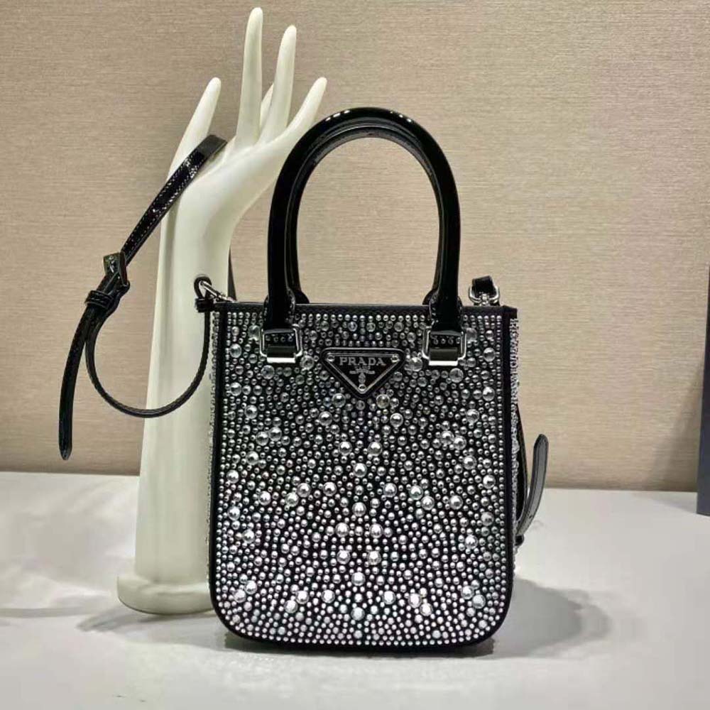 Close-up of crystal-studded detailing on Prada satin tote bag