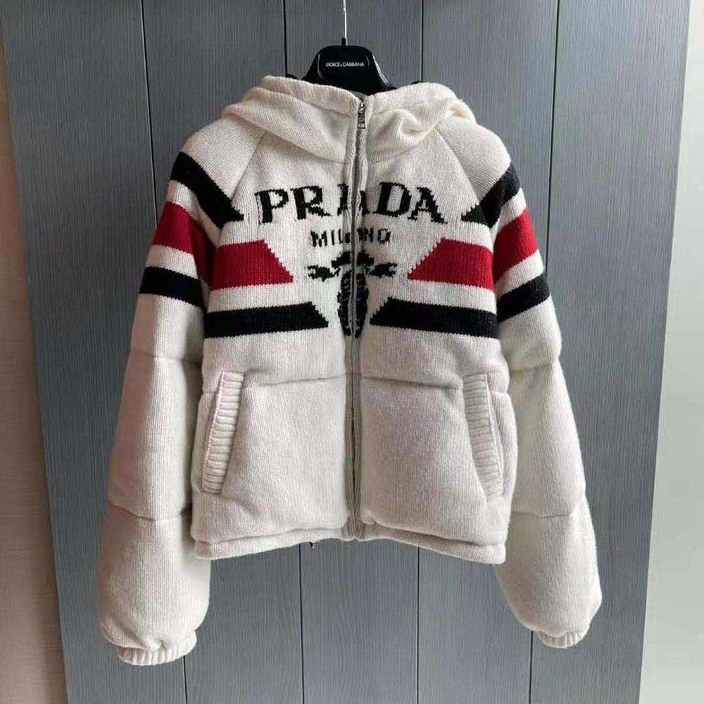 Close-up of silver hardware and Prada logo on white cashmere jacket
