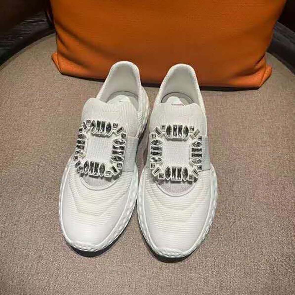 Close-up of Strass crystal buckle on Roger Vivier women’s white sneakers