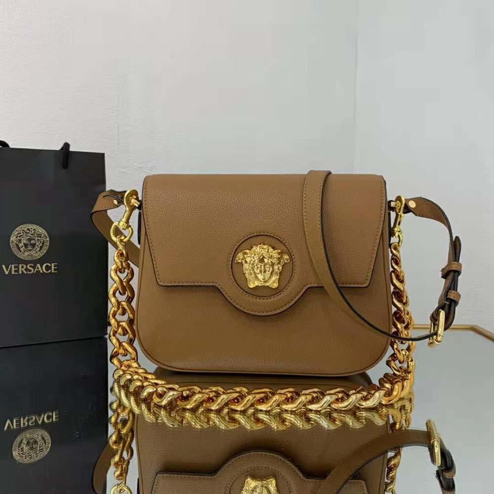 Close-up of smooth brown calfskin leather and gold-tone clasp on Versace Women La Medusa Shoulder Bag-Brown