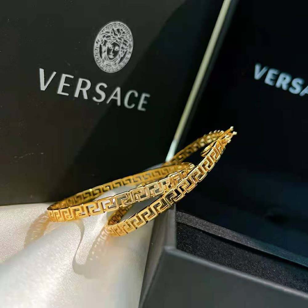 Side view of Versace Women Large Greca Hoop Earrings-Gold highlighting hoop size