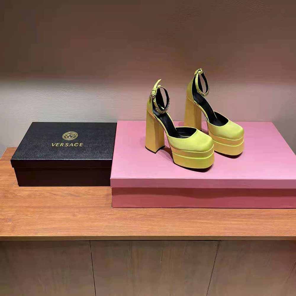 Close-up of gold Medusa emblem on Versace Women Medusa Aevitas Platform Pumps-Yellow