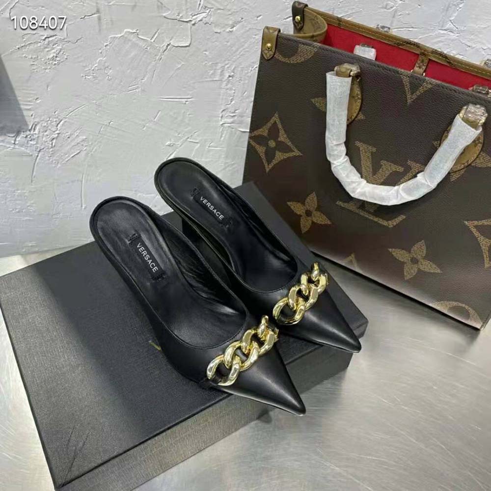 Close-up of gold Medusa chain on Versace Women Medusa Chain Nappa Leather Mules-Black