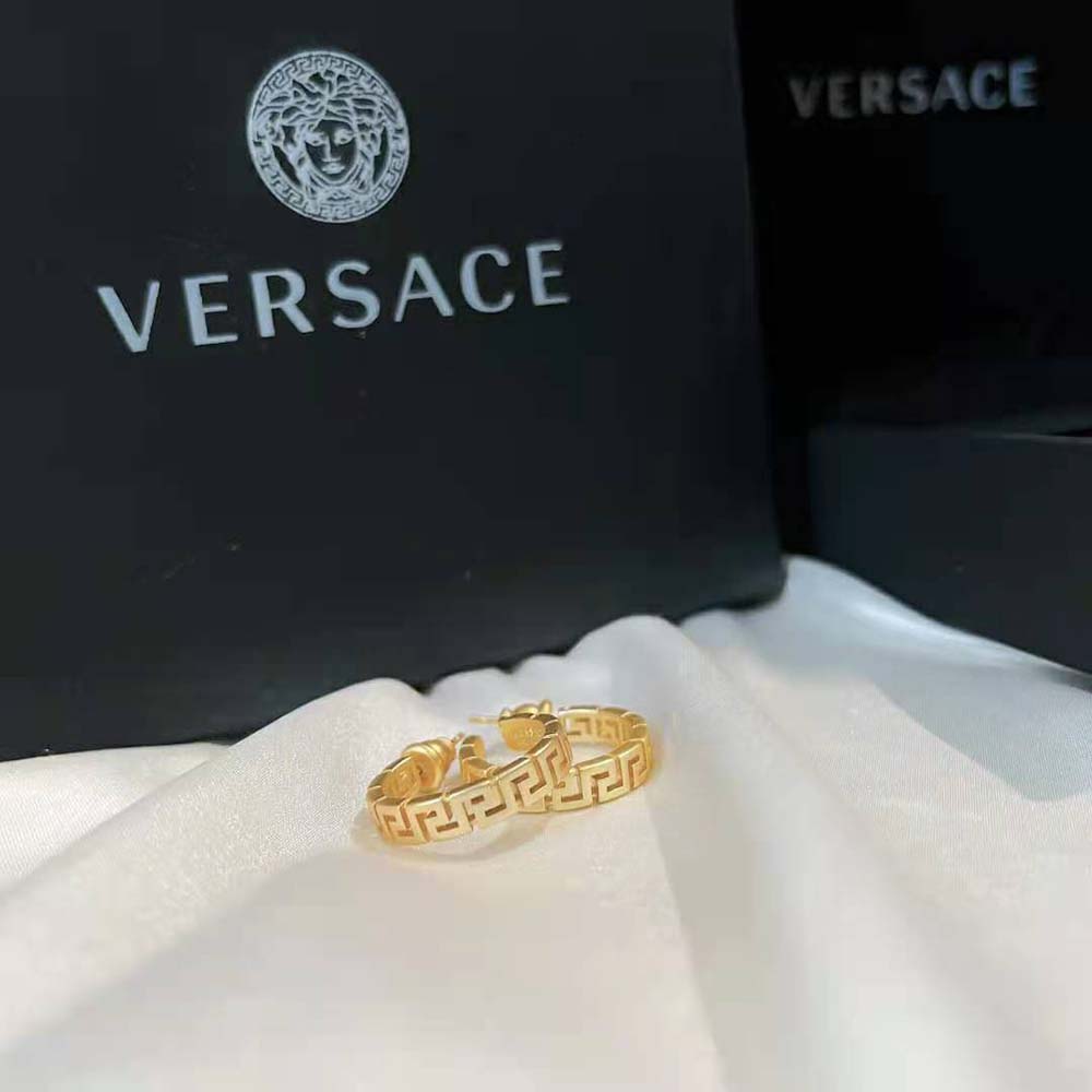 Close-up detail of gold plating and hinge closure on Versace Small Greca Hoop Earrings