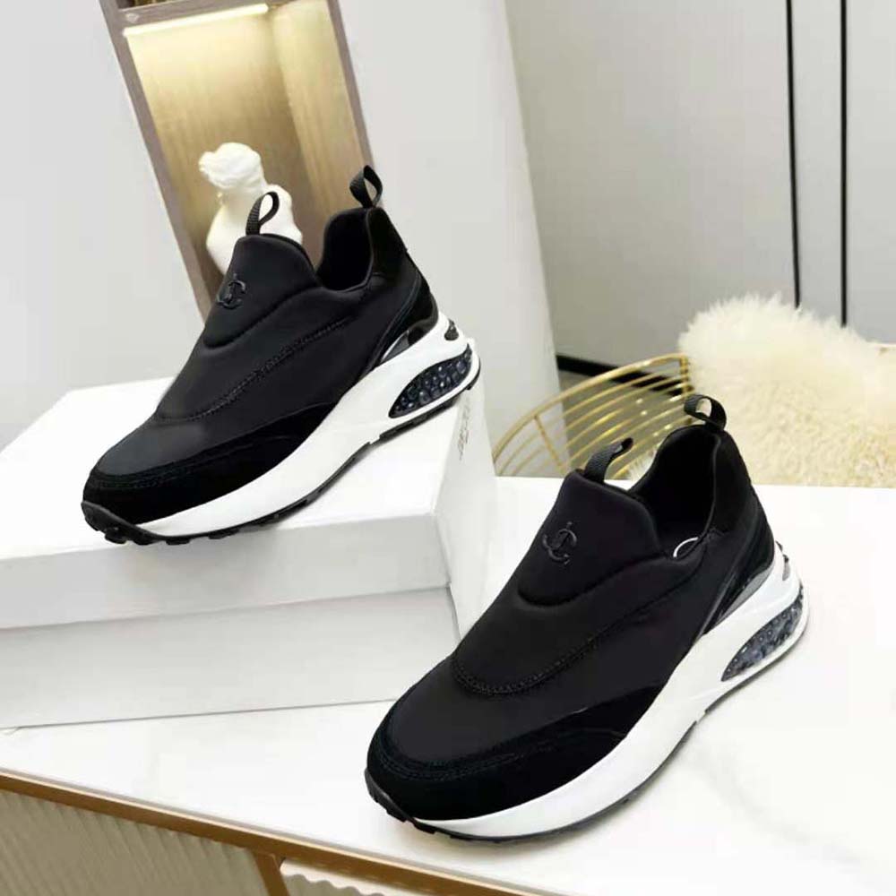 Close-up detail of black leather and neoprene on Jimmy Choo Memphis/F trainers