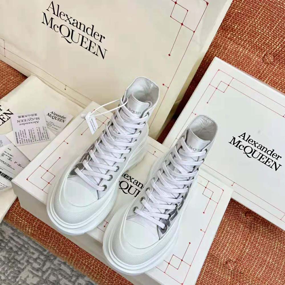 Close-up on white polyfaille fabric and lace-up detail of Alexander Mcqueen boot