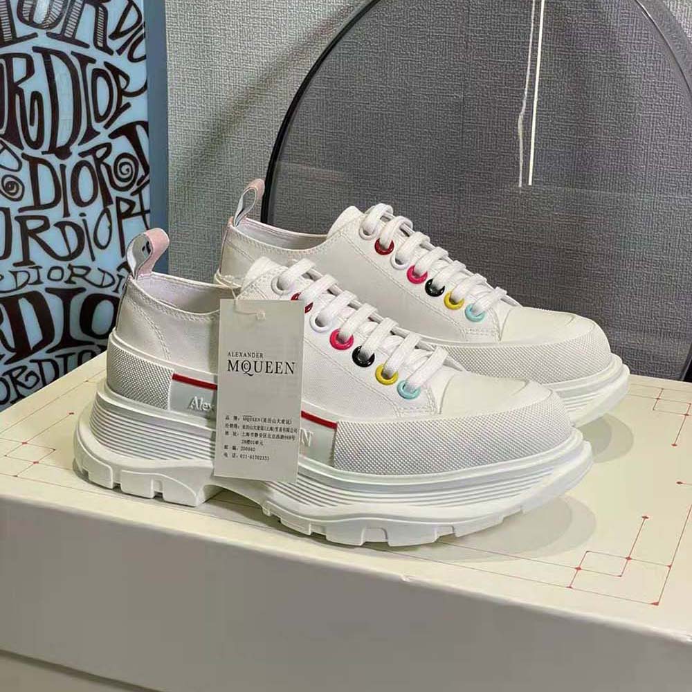 Close-up of lace-up and branded hardware on Alexander Mcqueen White Canvas sneakers