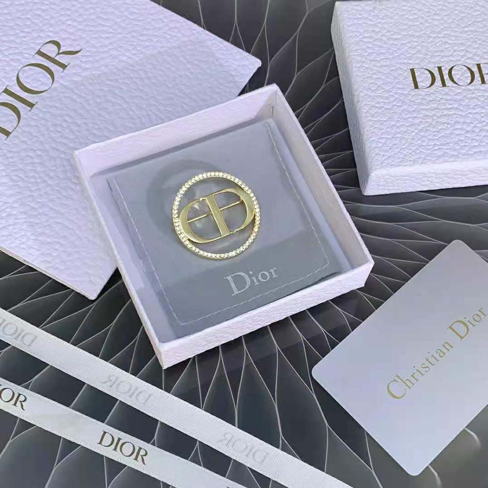 Close-up of white crystals on Dior Women 30 Montaigne Brooch gold finish