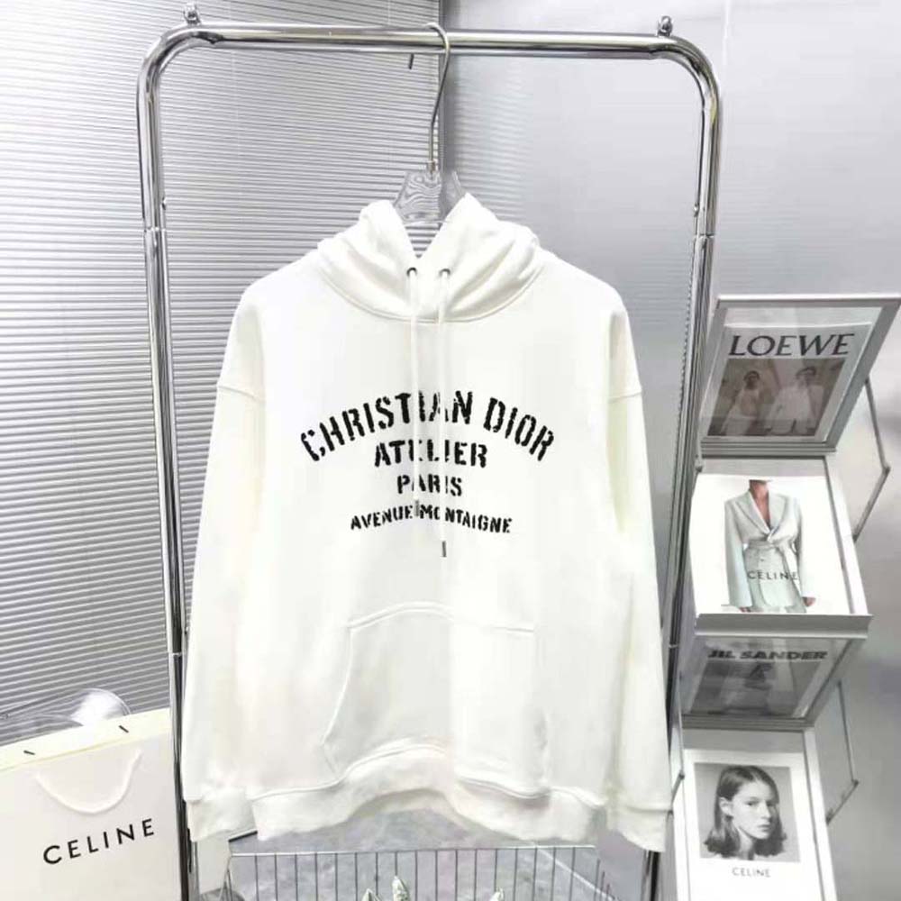 Close-up of Christian Dior Atelier embroidery detail on white sweatshirt