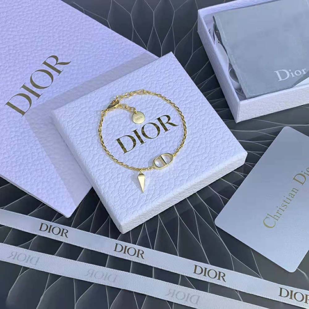 Dior Women Petit CD Bracelet gold-finish metal on wrist, angled view