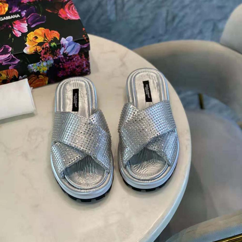 Close-up on silver padded nylon and sparkling rhinestone detail on Dolce Gabbana sliders