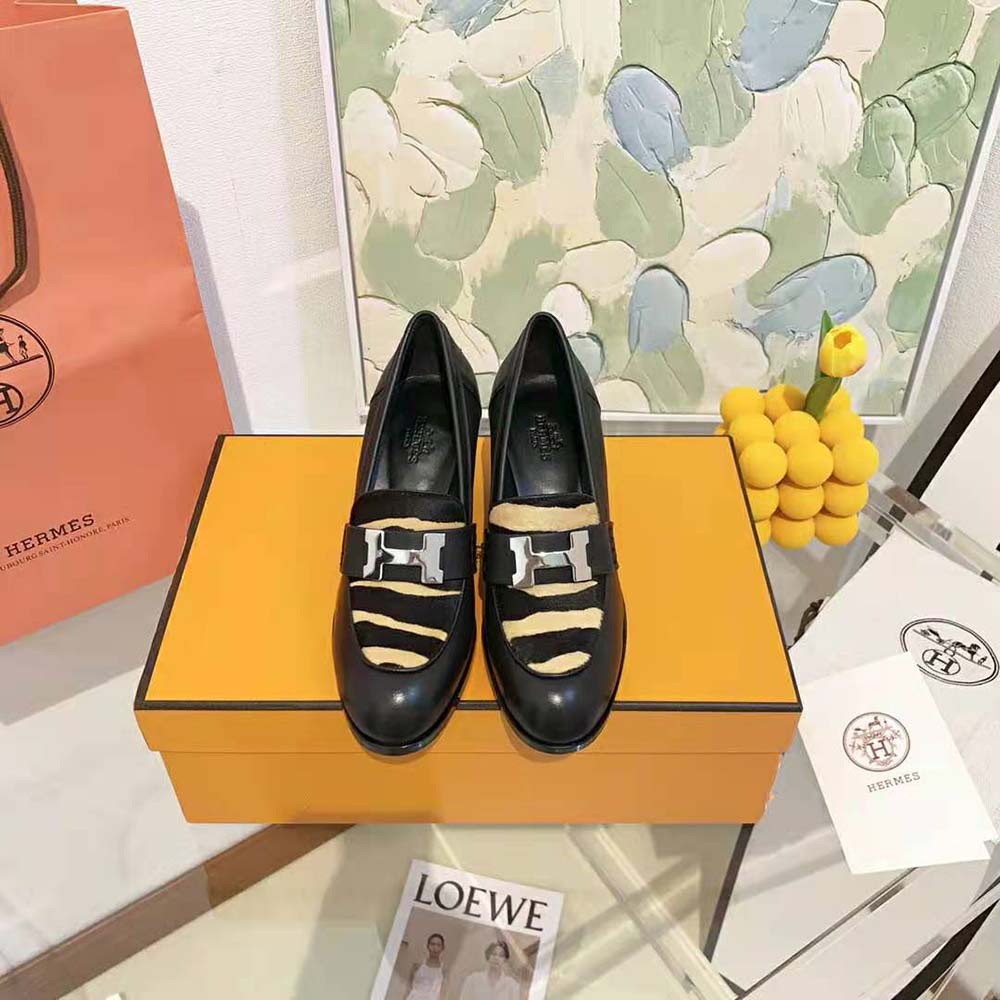 Close-up on black calfskin and signature Hermes hardware detail