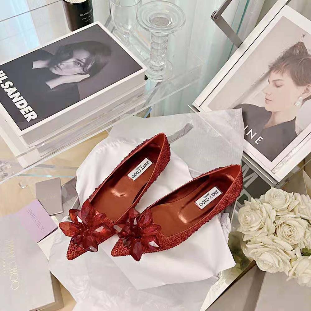 Close-up on the red satin and sparkling crystals of Jimmy Choo Women Attila Flats