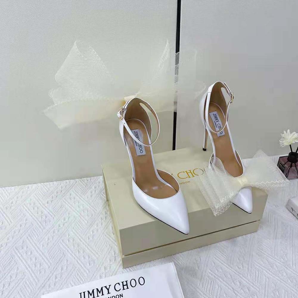 Close-up detail of asymmetric mesh fascinator bows on Jimmy Choo pumps
