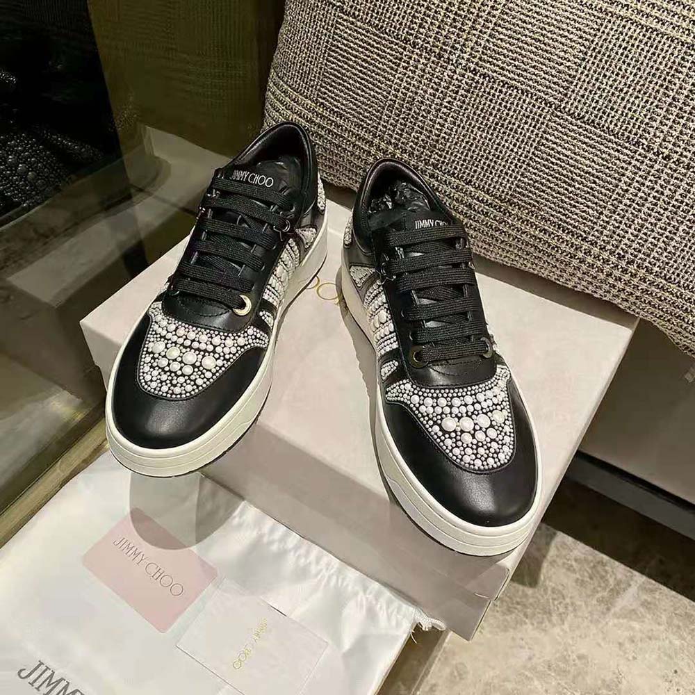 Close-up on lace-up and logo hardware of Jimmy Choo Women Hawaii/F trainers