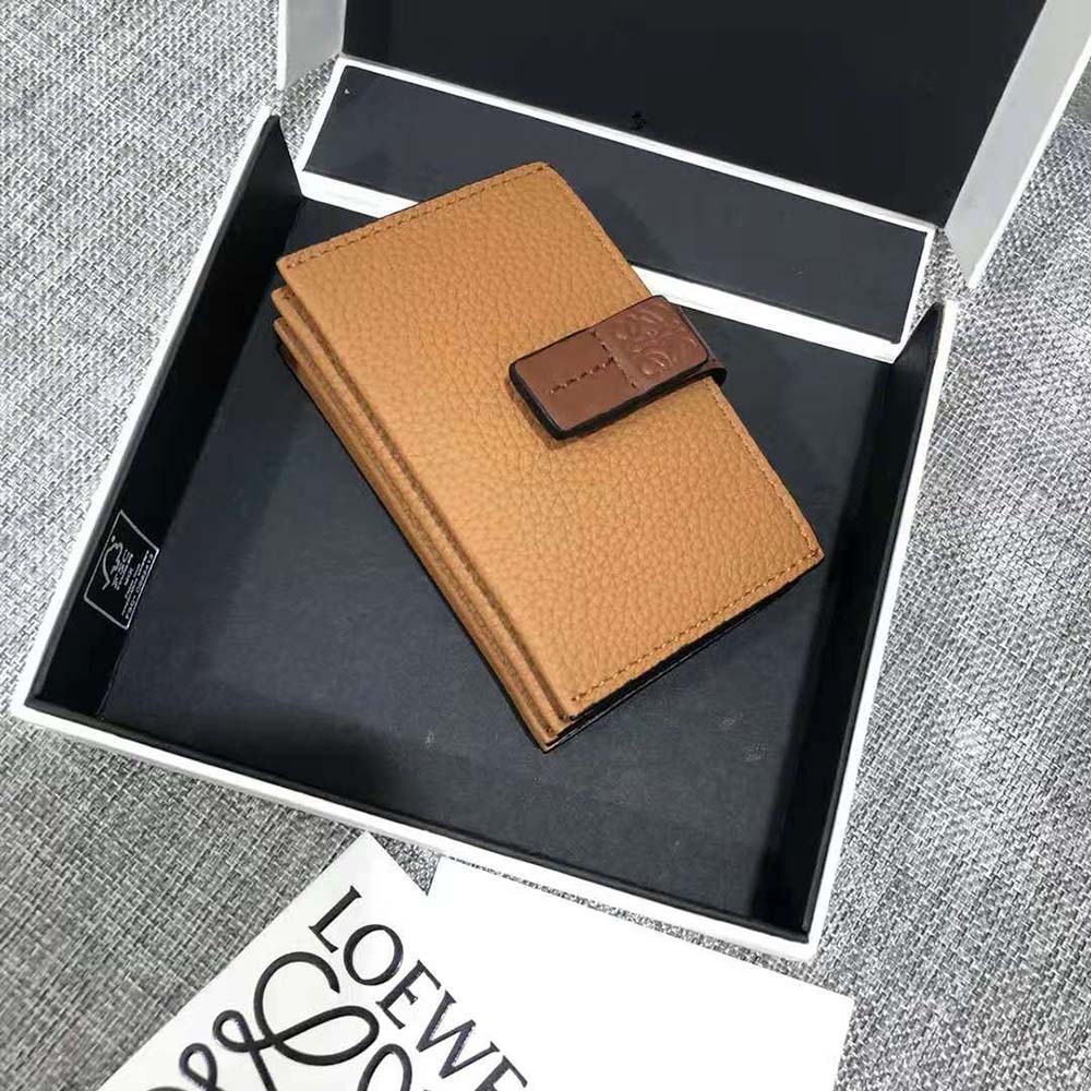 Close-up detail of accordion folds and gold Loewe embossing on cardholder