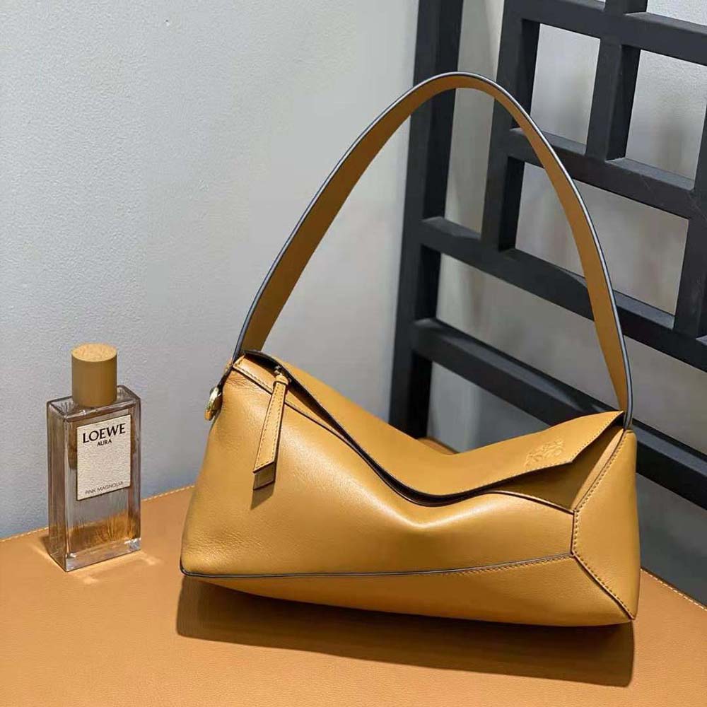 Side view showing soft structure and hardware of Loewe Puzzle Hobo Bag