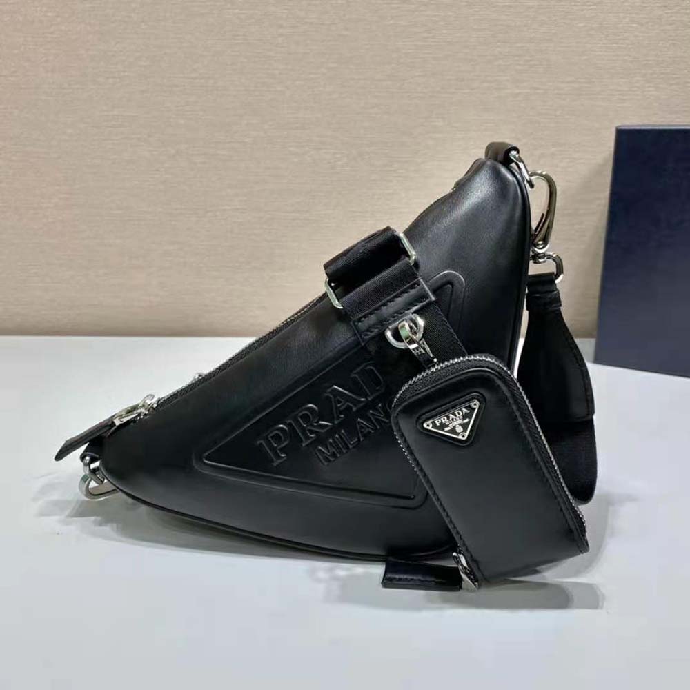 Close-up of black leather texture and triangular Prada logo detail