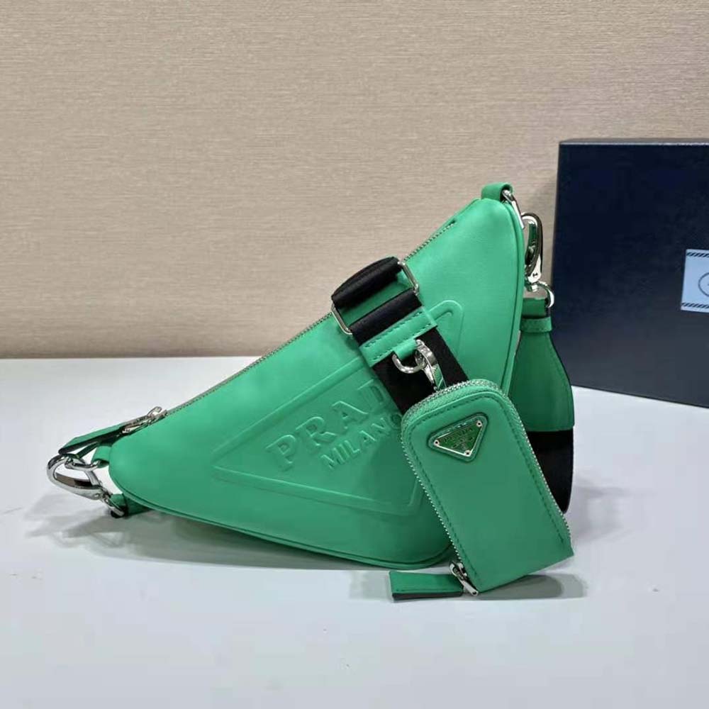 Close-up on green leather texture and silver hardware of Prada Triangle Shoulder Bag