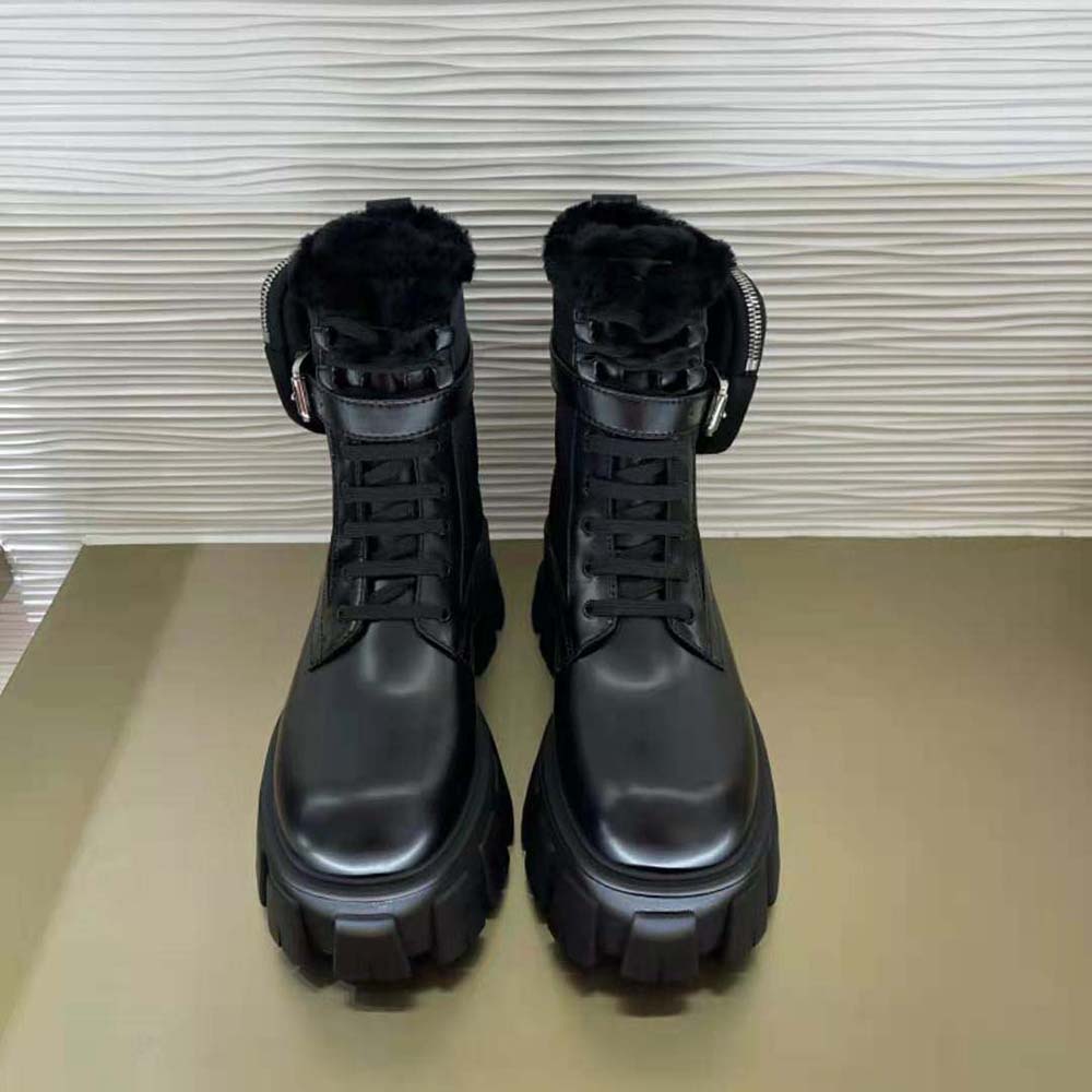 Side view highlighting leather and nylon panels on Prada Women Monolith boots