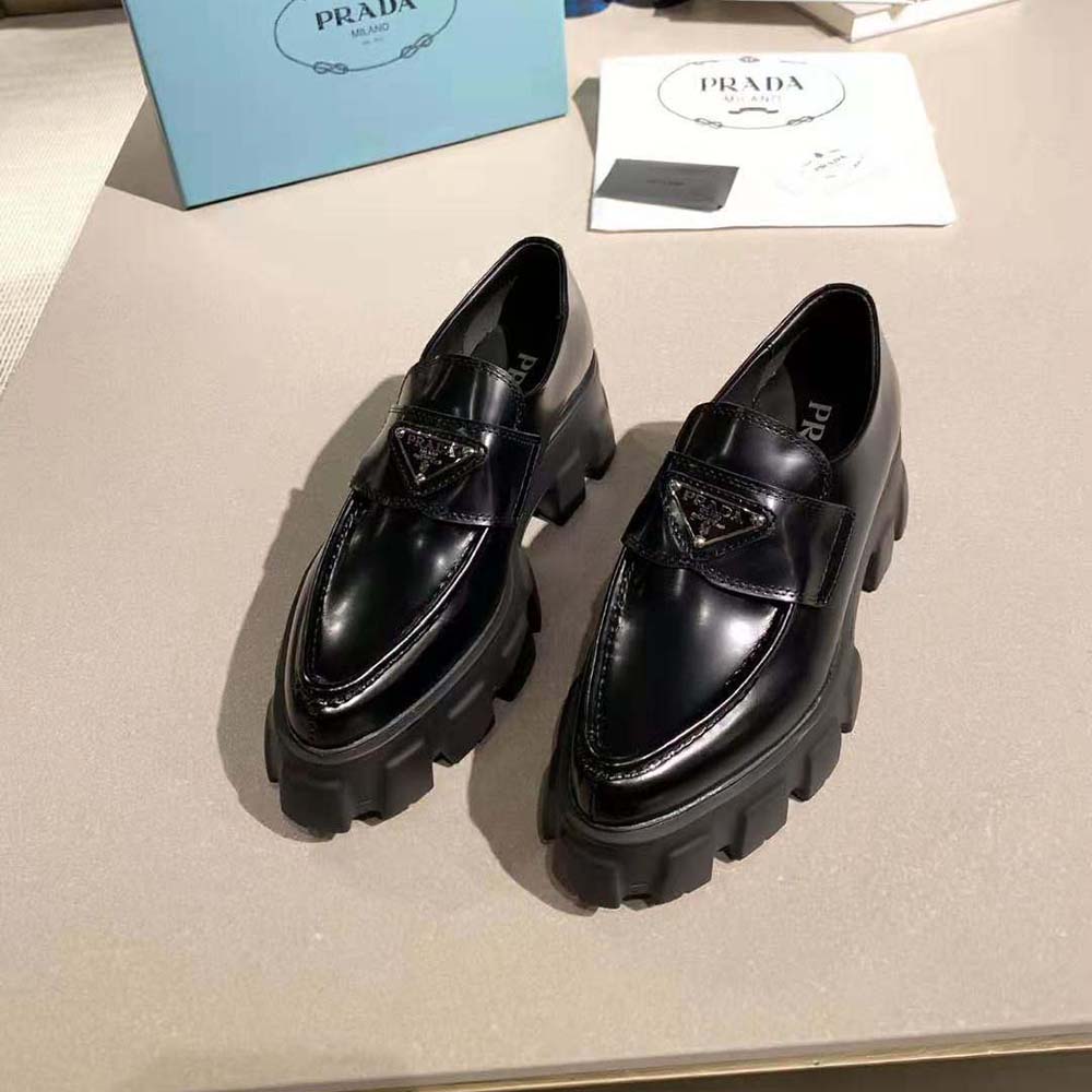 Close-up on the brushed leather and monolith sole detail of Prada loafer