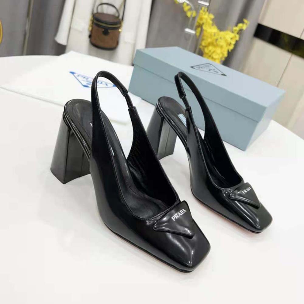 Heel and embossed Prada logo on black patent leather sling-back pumps