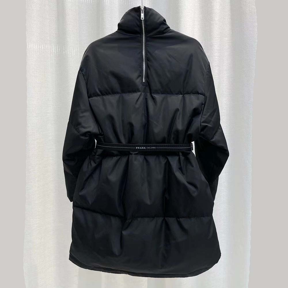 Close-up of Prada logo hardware on the black down coat collar