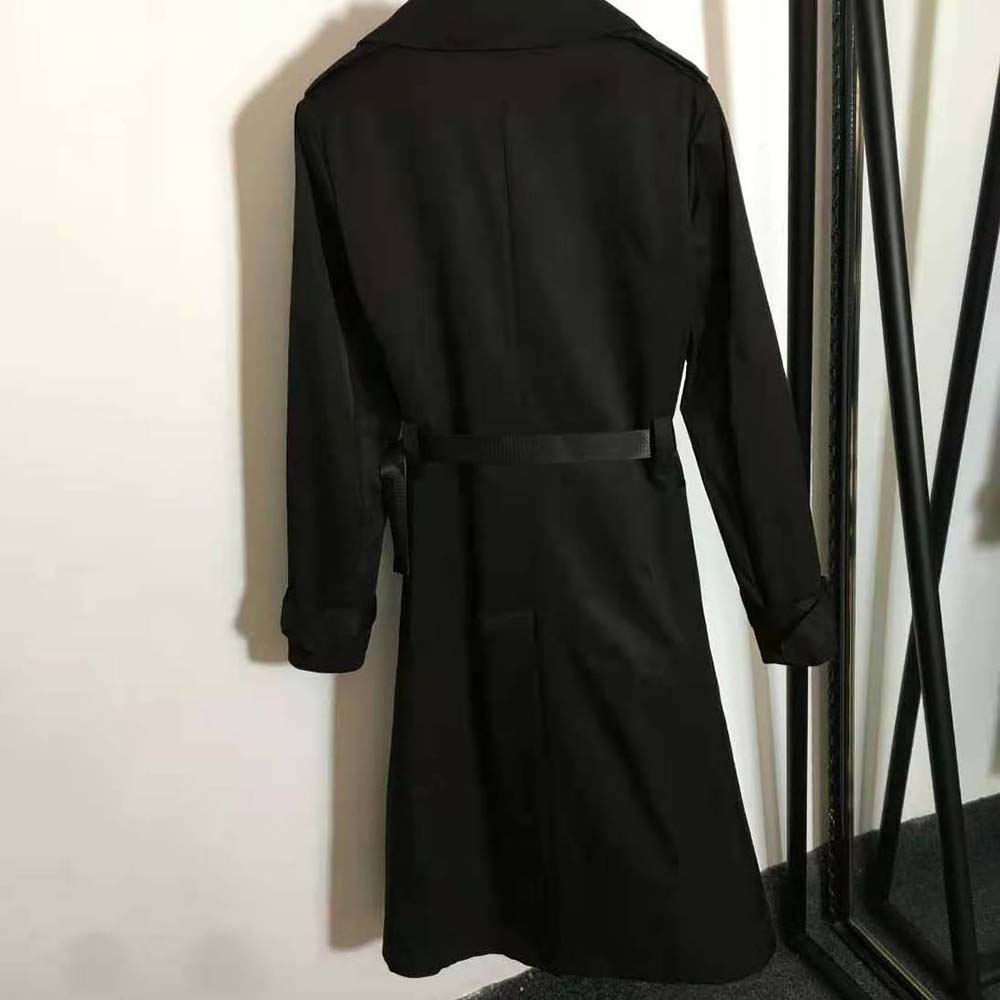 Side angle of Prada Women Re-Nylon Gabardine Trench Coat-Black detailing fabric texture