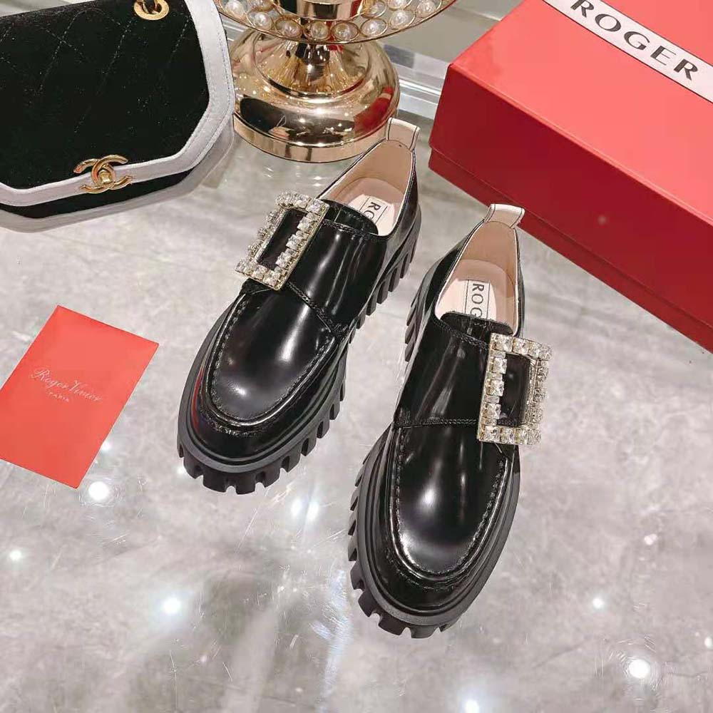 Close-up of oversized strass buckle on Roger Vivier patent leather loafer