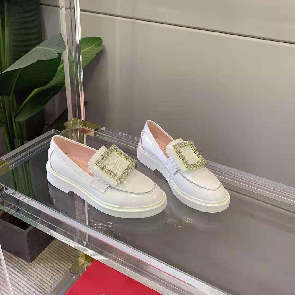 Top view showing white leather and signature buckle of Roger Vivier loafers